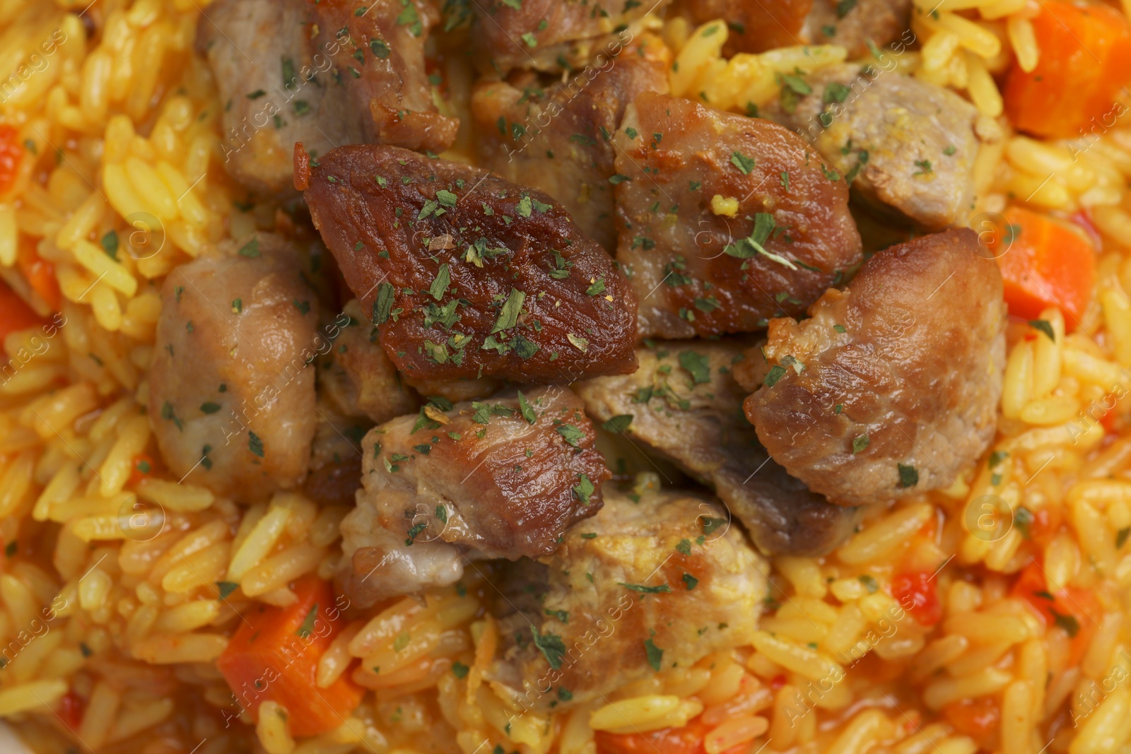 Photo of Delicious pilaf with meat as background, closeup