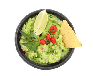Photo of Delicious guacamole served with nachos chips, lime and pepper isolated on white, top view