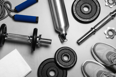 Photo of Gym equipment on light grey background, flat lay