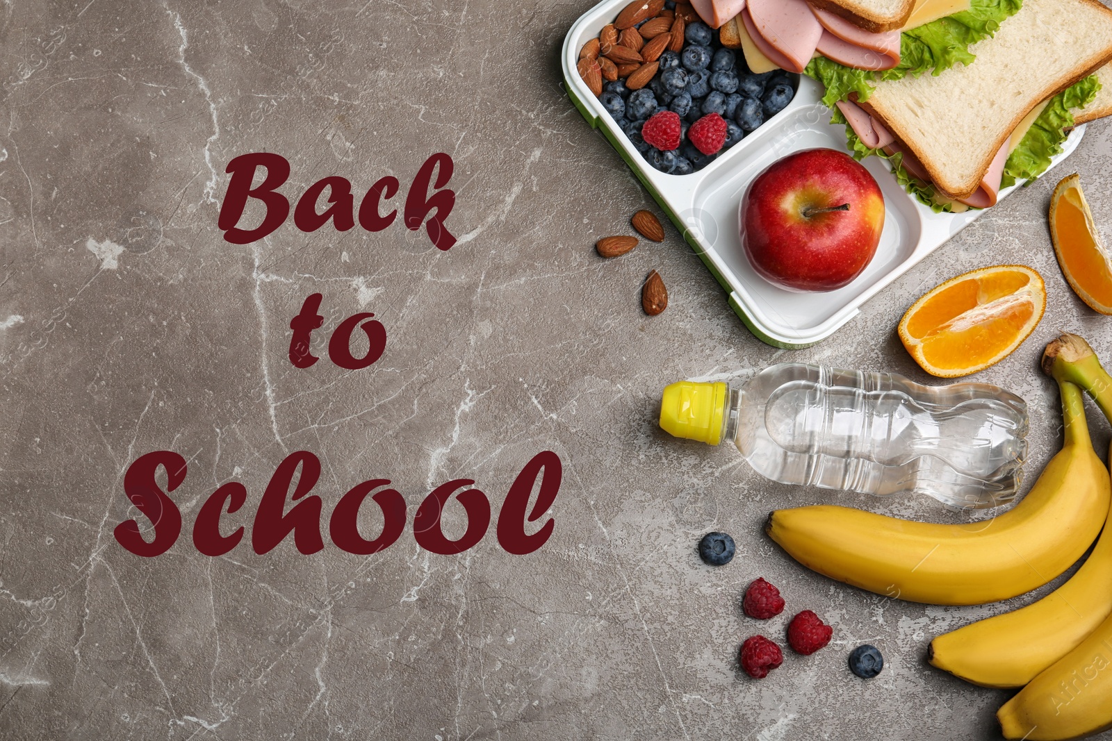 Image of Flat lay composition with healthy food on brown marble table. School lunch