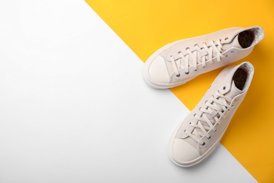 Photo of Pair of sneakers on color background, top view