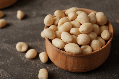 Shelled peanuts in wooden bowl on table