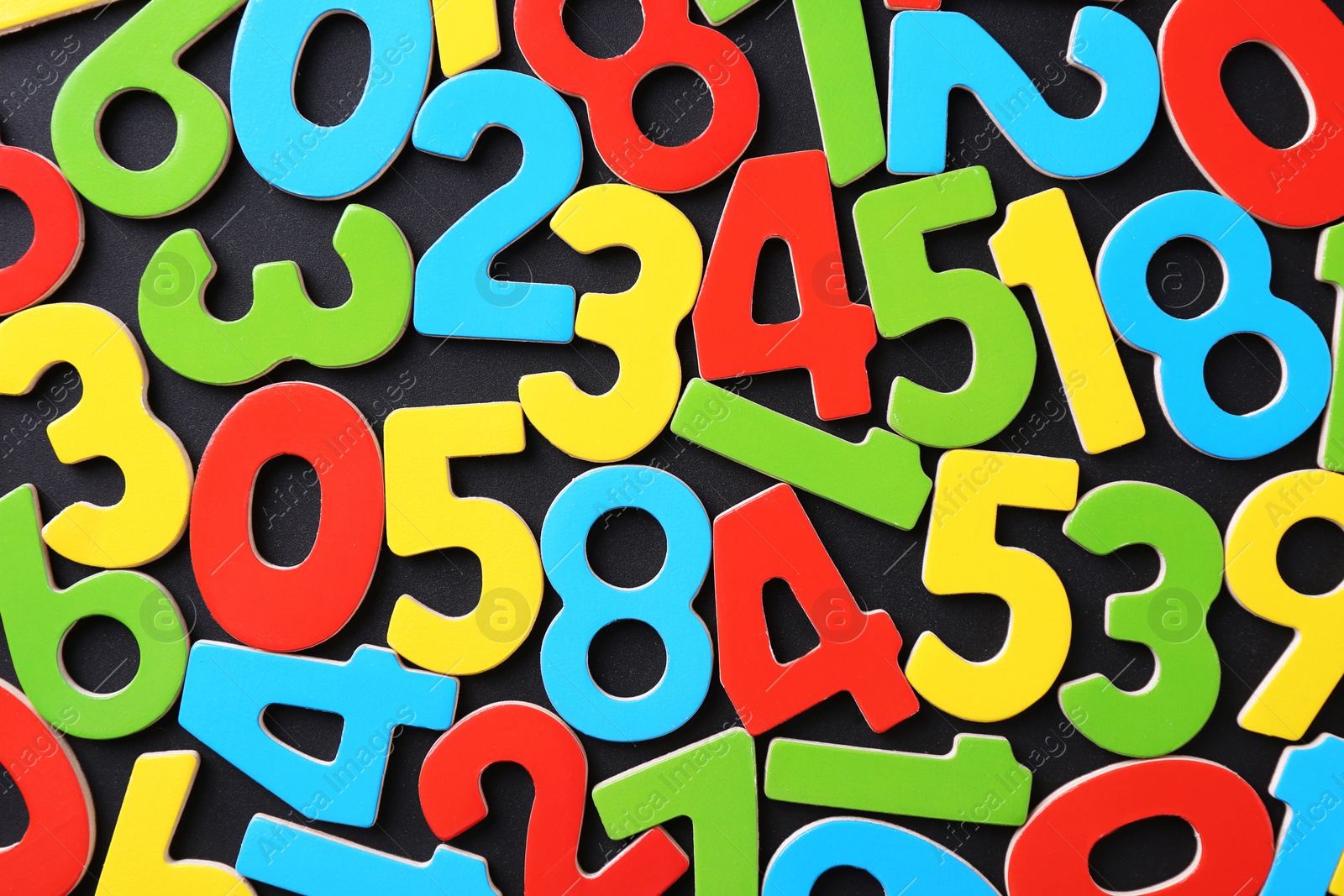 Photo of Colorful numbers on black background, top view