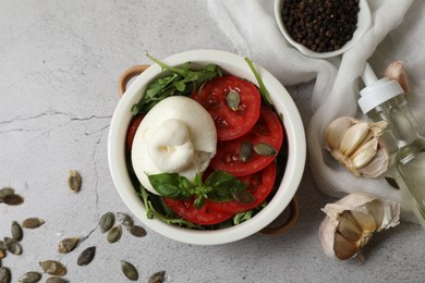 Photo of Flat lay composition with delicious burrata cheese and tomatoes on light grey table