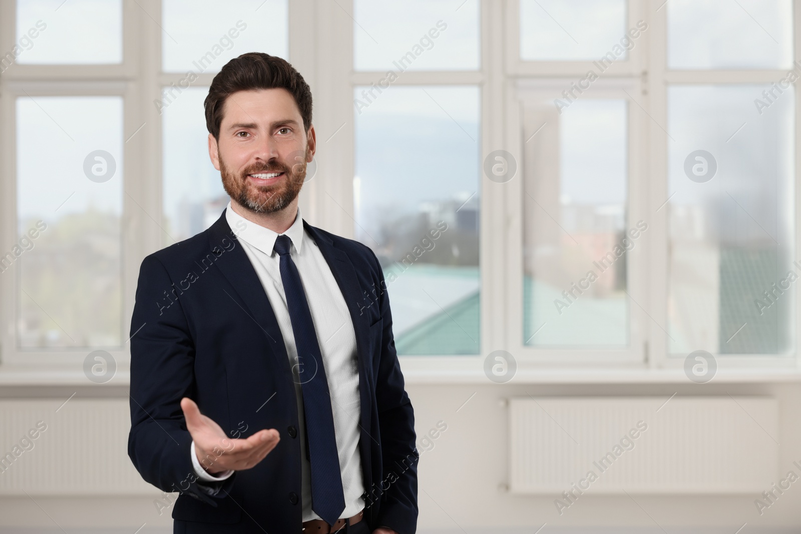 Photo of Happy real estate agent in new apartment. Space for text