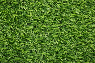 Photo of Green artificial grass as background, top view