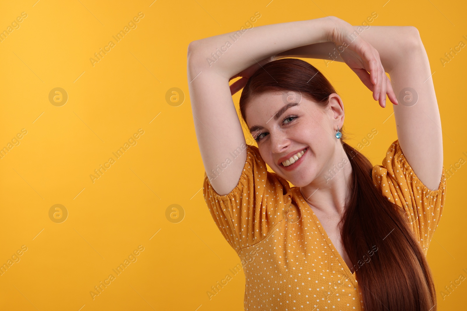 Photo of Portrait of smiling woman on yellow background. Space for text