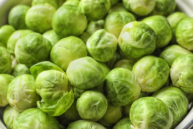 Photo of Tasty fresh Brussels sprouts in dish, closeup