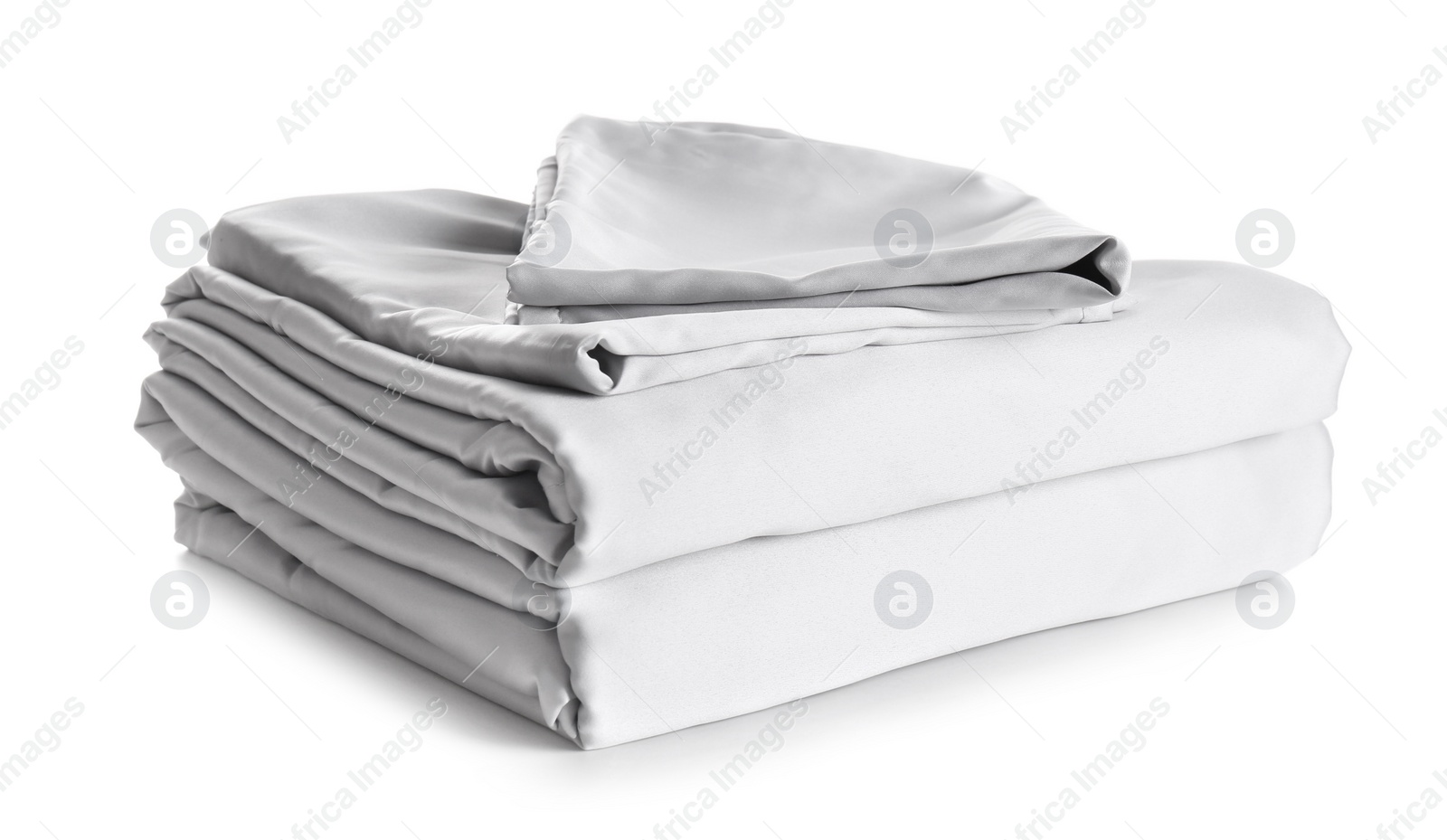 Photo of Stack of clean silky bed linen isolated on white