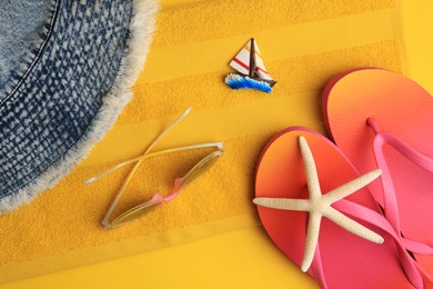 Flat lay composition with beach accessories on orange background