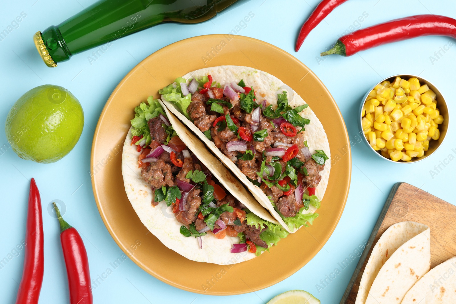 Photo of Flat lay composition with delicious tacos on light blue table