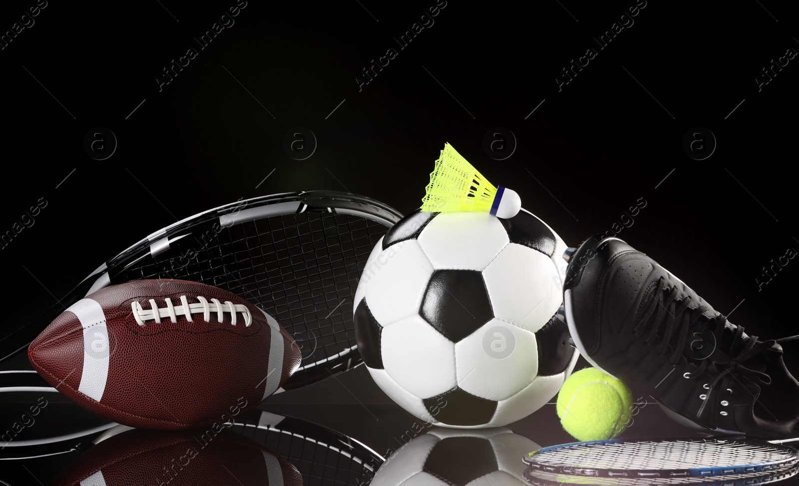 Photo of Many different sports equipment on black mirror surface