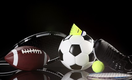 Photo of Many different sports equipment on black mirror surface