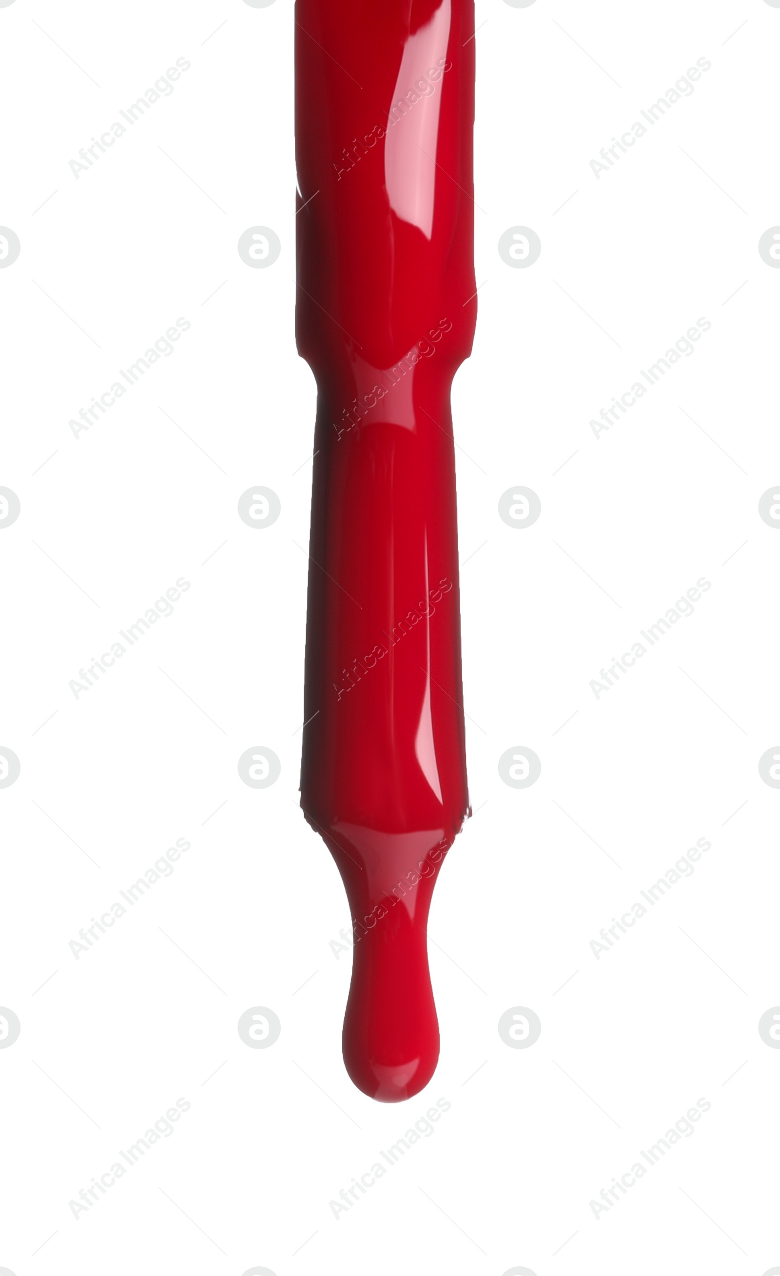 Photo of Red nail polish dripping from brush isolated on white