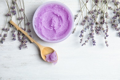 Flat lay composition with lavender flowers and natural cosmetic on wooden background