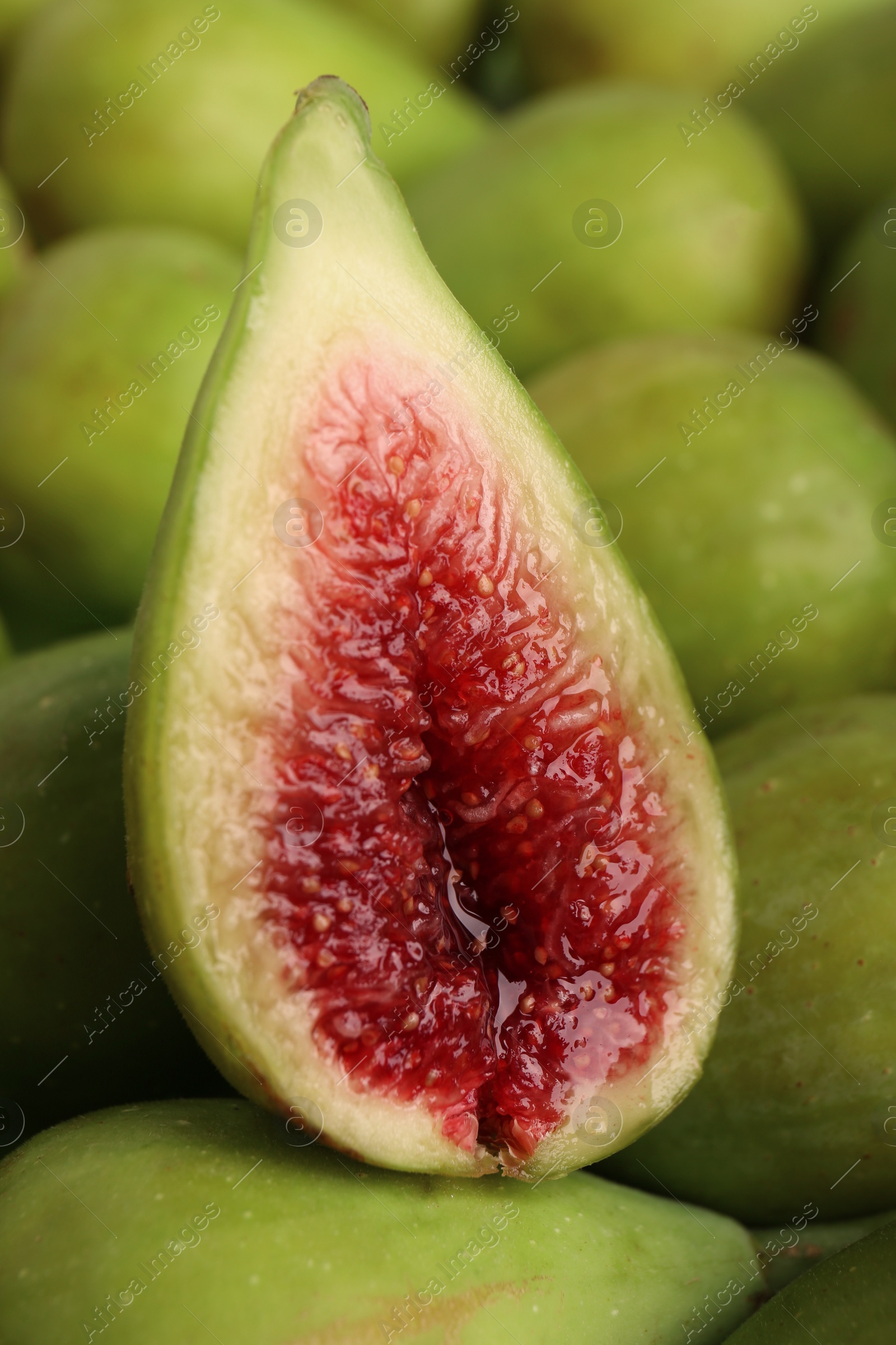 Photo of Half of green fig on fresh fruits, closeup