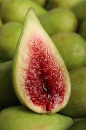 Half of green fig on fresh fruits, closeup