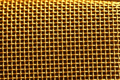 Image of Metal mesh of golden microphone as background, closeup