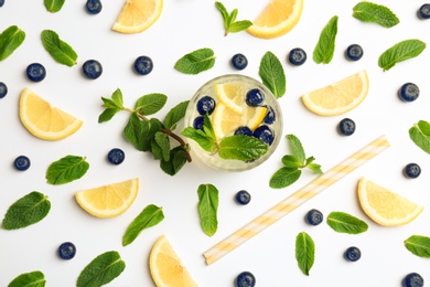 Photo of Flat lay composition with delicious natural lemonade on white background