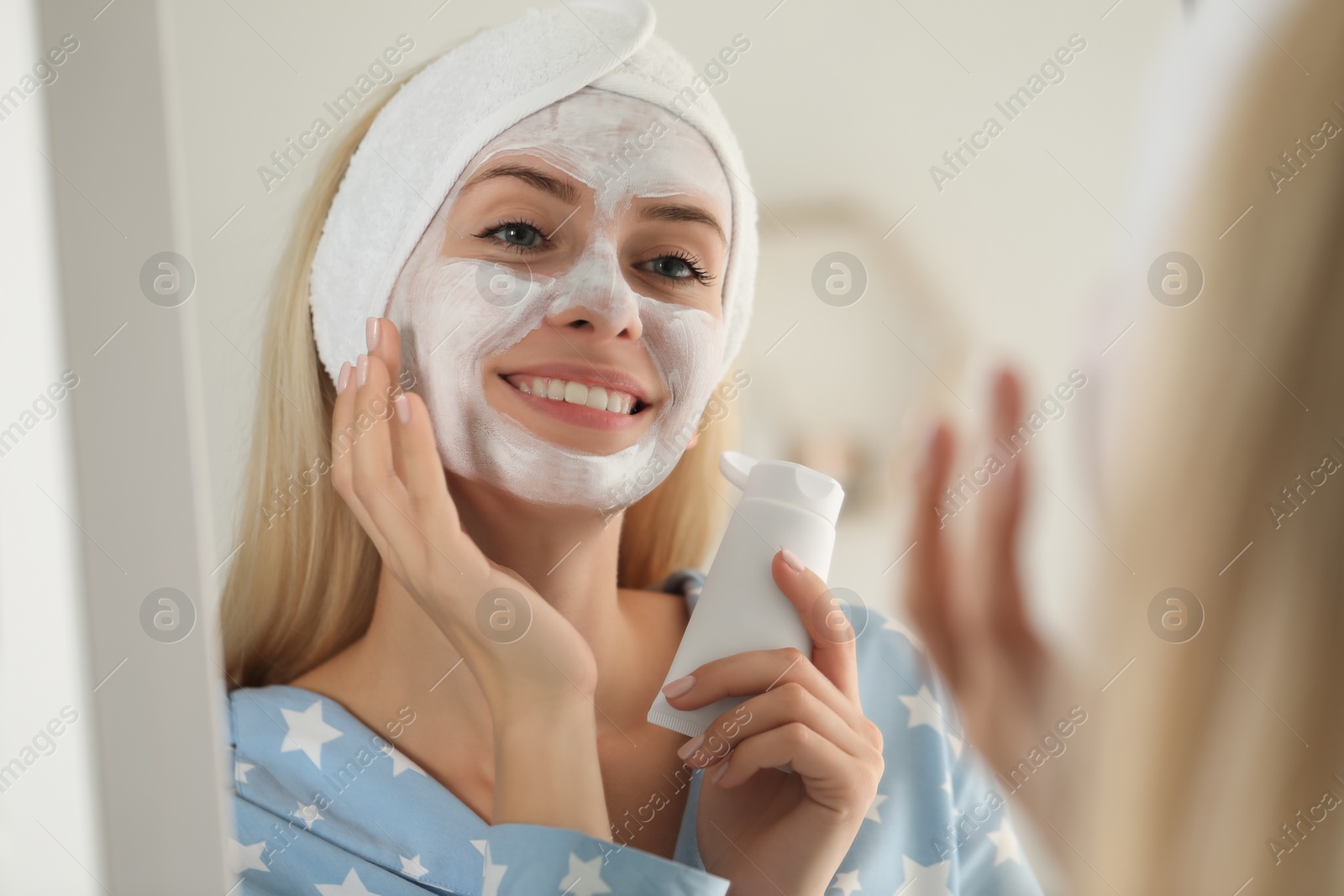 Photo of Young woman applying face mask at home. Spa treatments