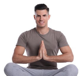 Photo of Handsome man meditating on white background. Harmony and zen