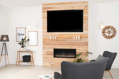 Photo of Living room interior with decorative fireplace in wooden wall