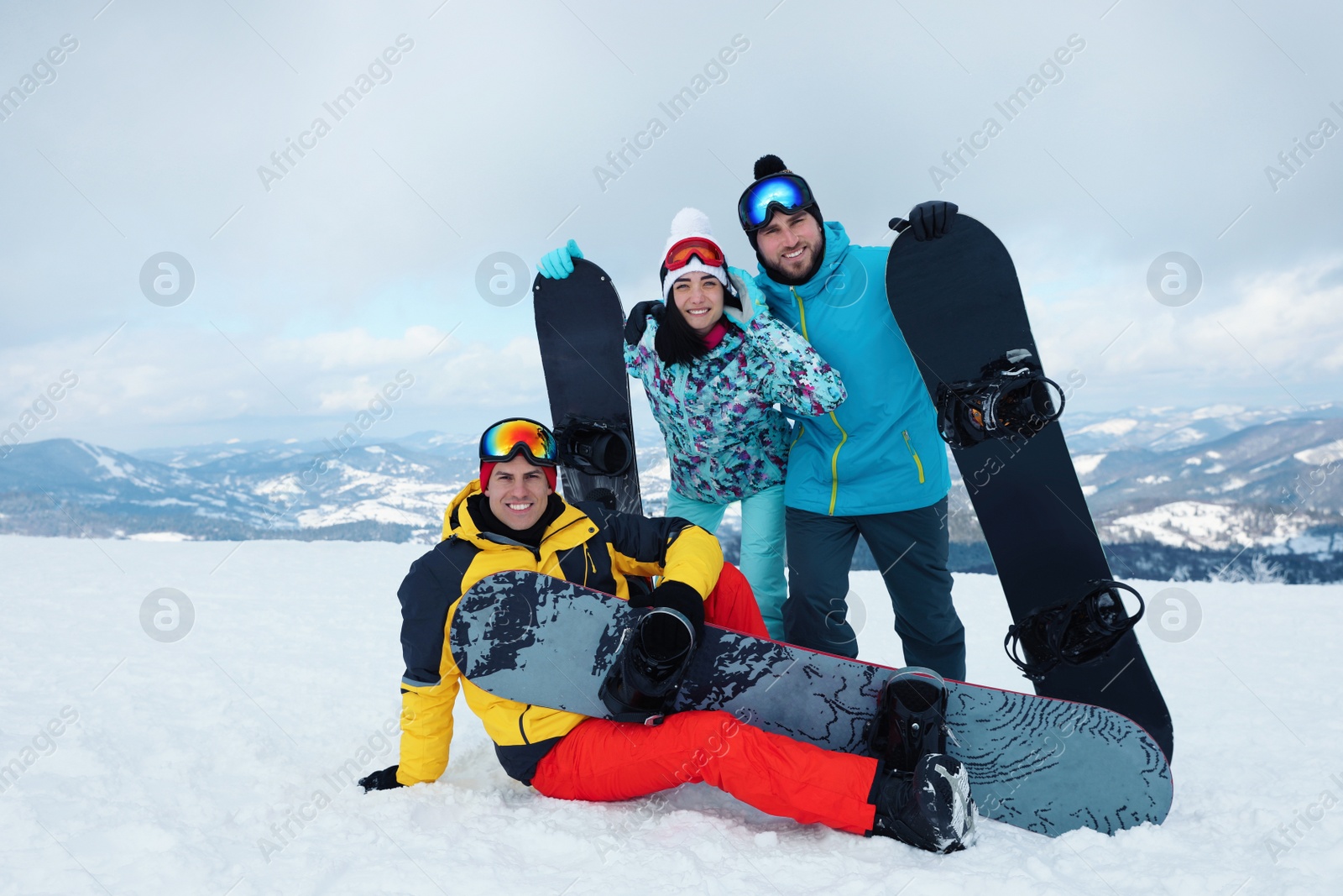 Photo of Group of friends with equipment in snowy mountains. Winter vacation