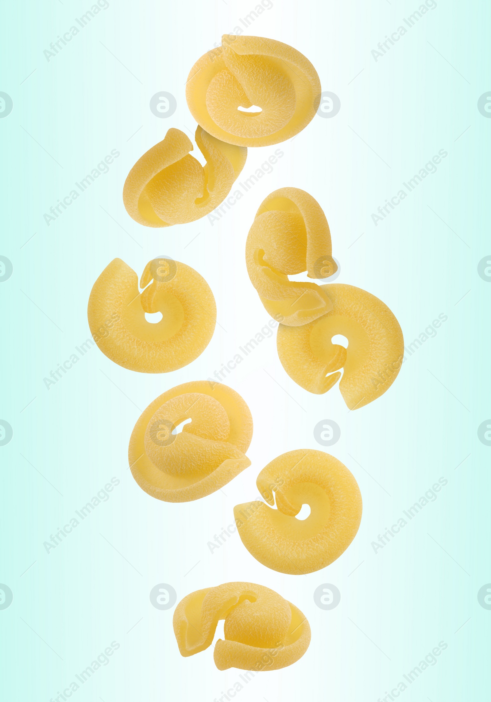 Image of Raw dischi volanti pasta flying on aquamarine background