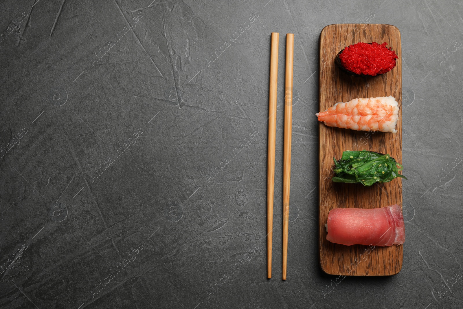 Photo of Set of delicious sushi on grey table, flat lay. Space for text