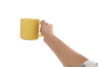 Woman holding elegant yellow cup on white background, closeup