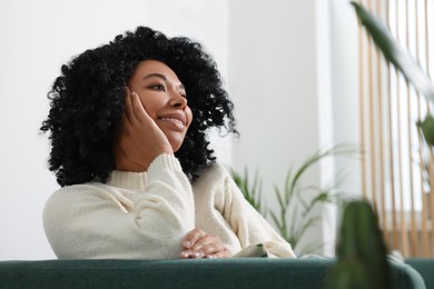 Photo of Relaxing atmosphere. Woman surrounded by beautiful houseplants indoors