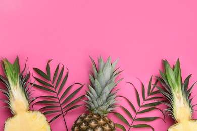 Photo of Whole and cut ripe pineapples on pink background, flat lay. Space for text