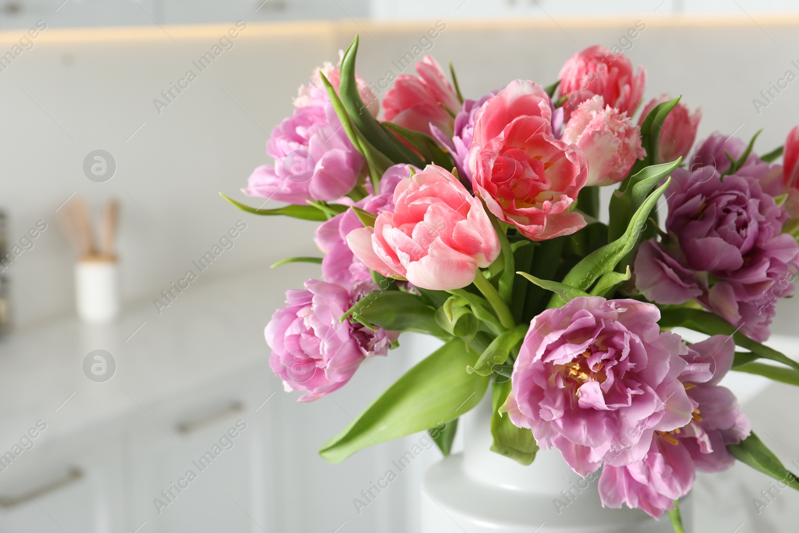 Photo of Beautiful bouquet of colorful tulip flowers indoors, closeup. Space for text