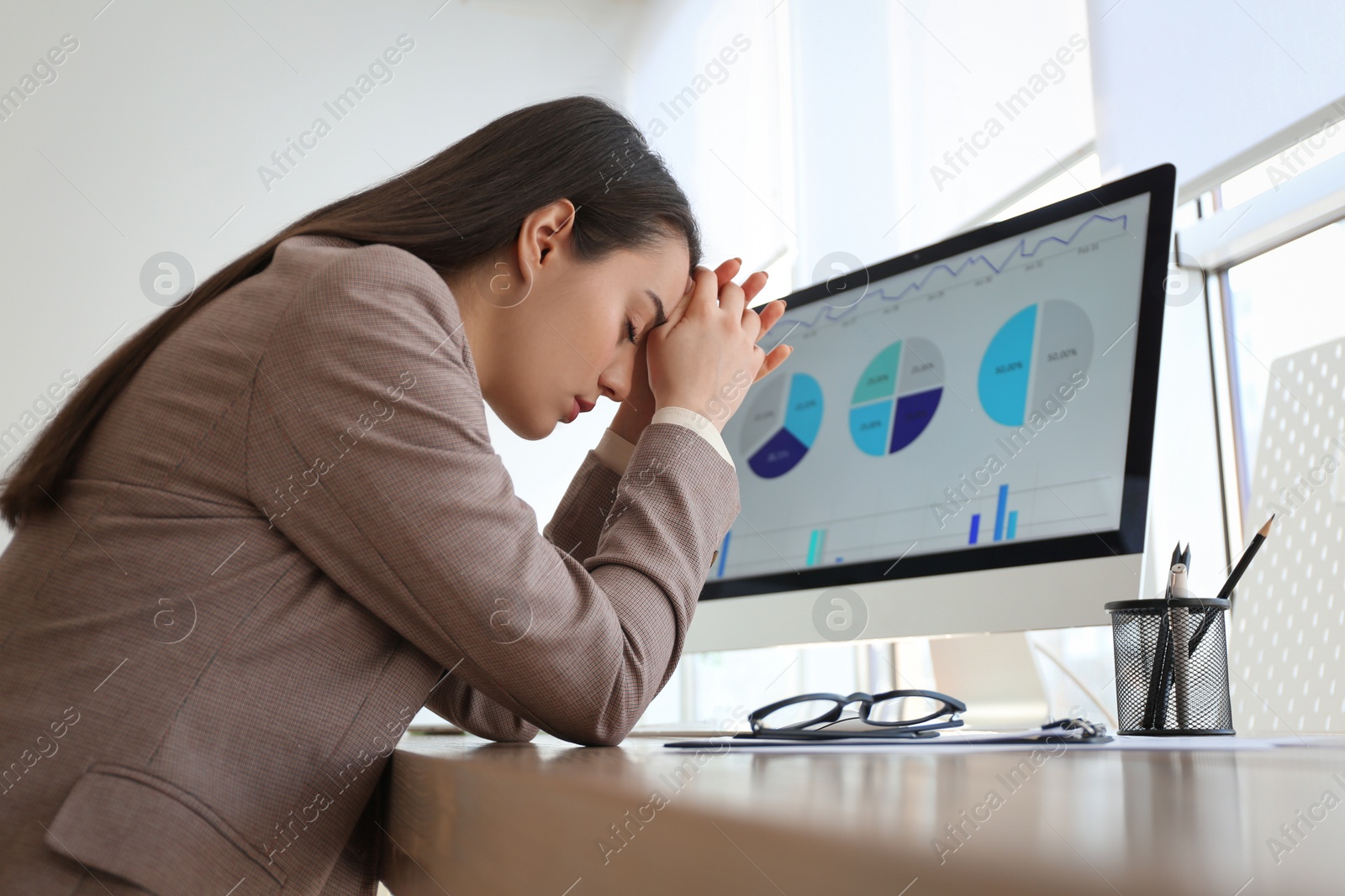 Photo of Businesswoman stressing out at workplace in office