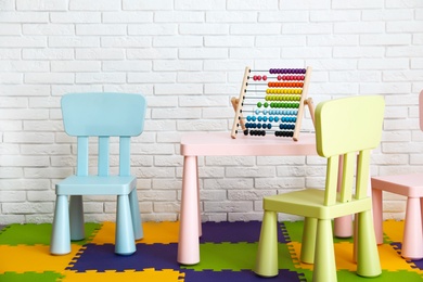 Photo of Stylish playroom interior with toys and modern furniture