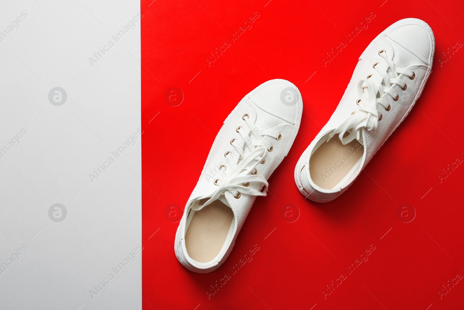 Photo of Stylish sneakers on color background, top view with space for text