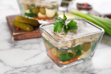 Photo of Delicious aspic with meat and vegetables served on white marble table