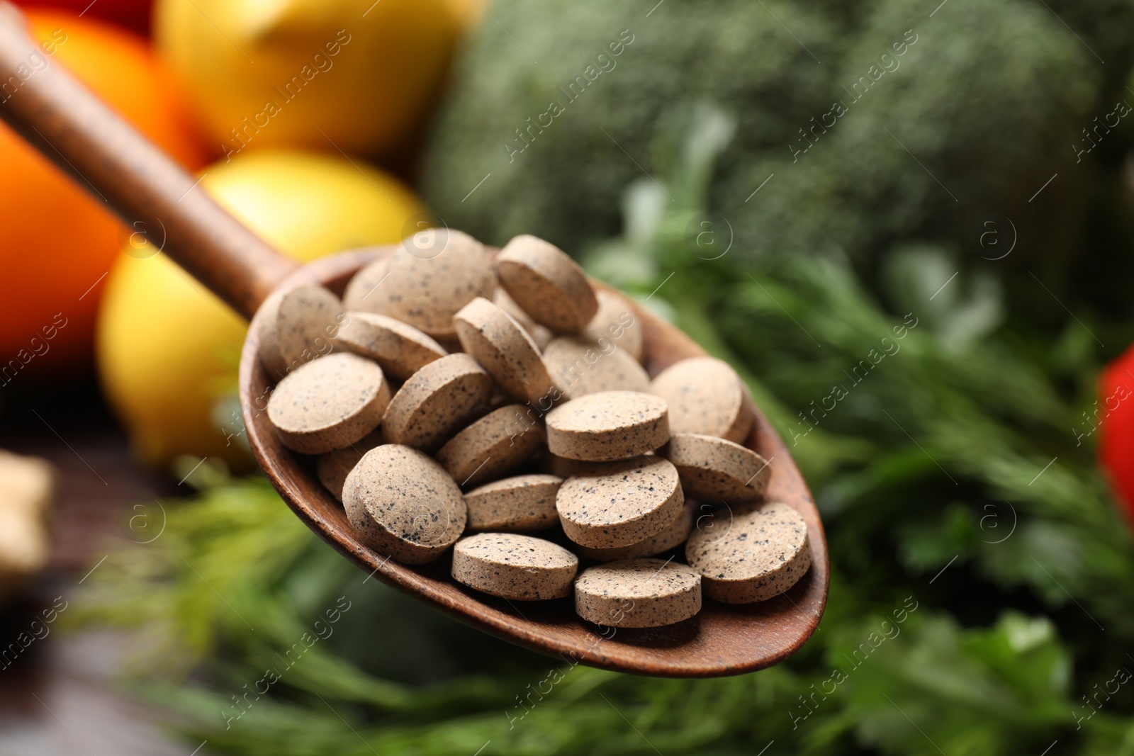 Photo of Dietary supplements. Spoon with pills over food products, closeup