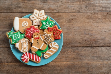 Photo of Tasty homemade Christmas cookies on wooden table, top view. Space for text