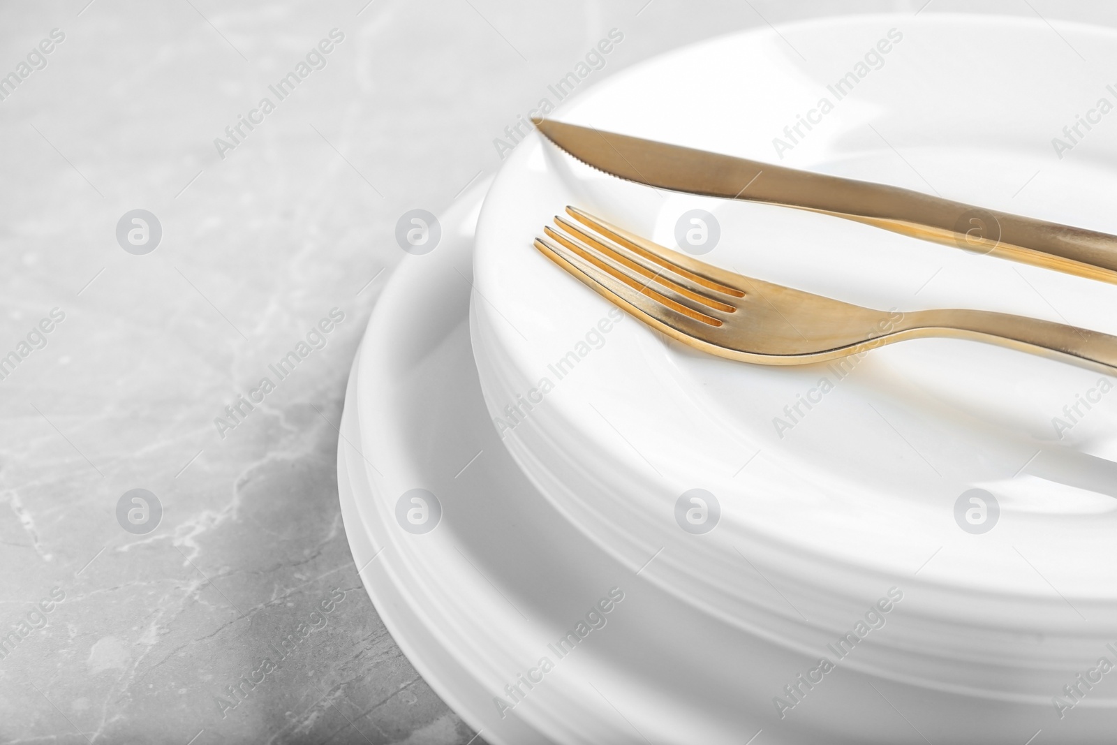 Photo of Stack of plates with fork and knife, closeup