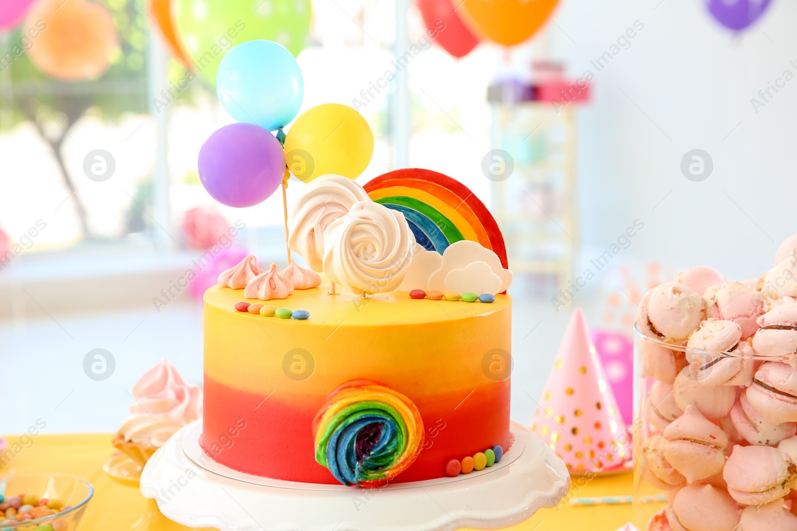 Photo of Table with birthday cake and delicious treats indoors