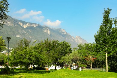 Beautiful view of park and green mountains on sunny day