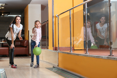 Mother and daughter spending time together in bowling club