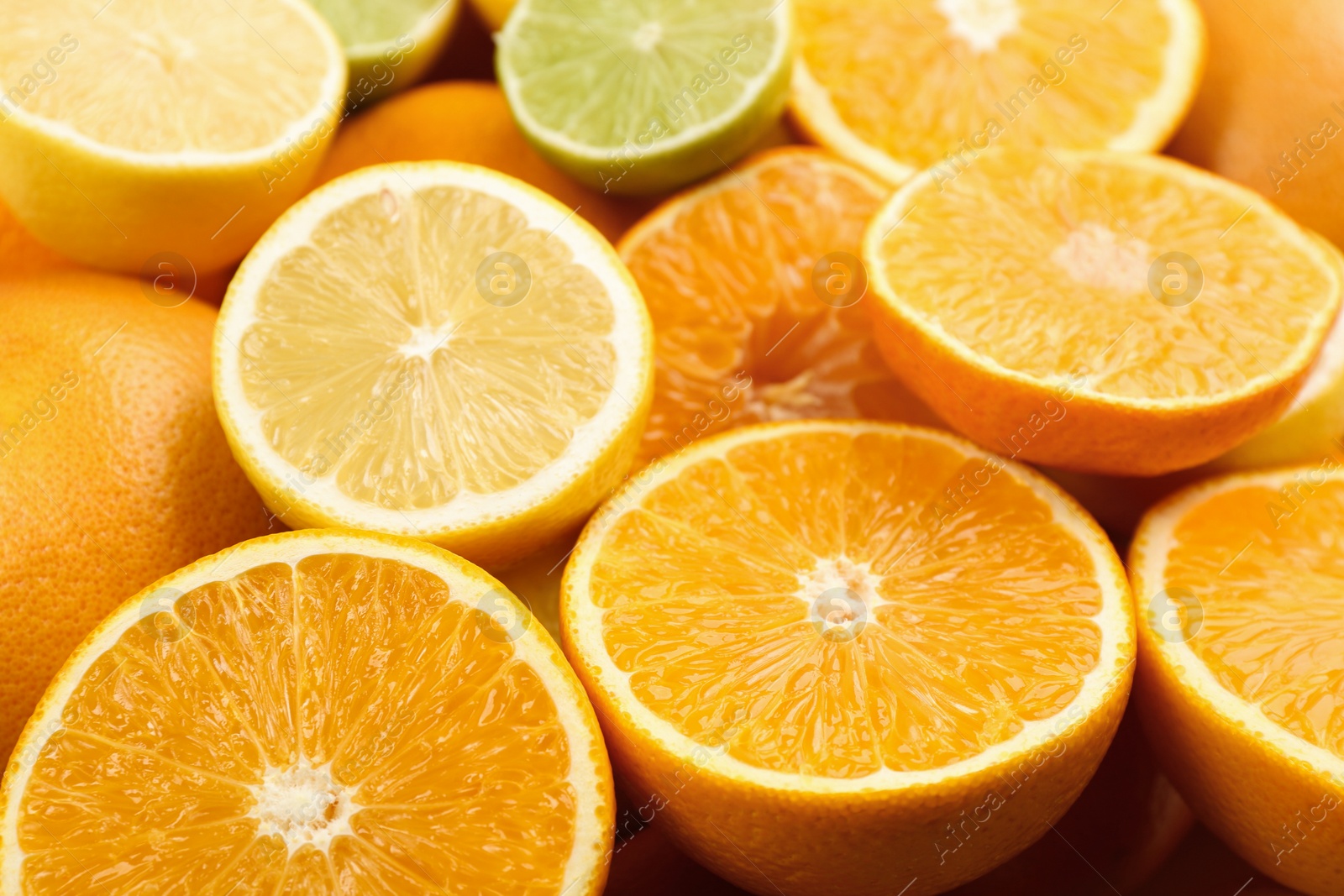 Photo of Closeup view of cut tangerines, oranges, lime and lemon