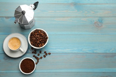 Coffee maker, beans, powder and cup of drink on light blue wooden table, flat lay. Space for text