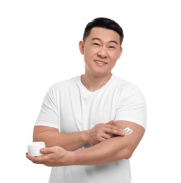 Photo of Handsome man applying body cream onto his arm on white background