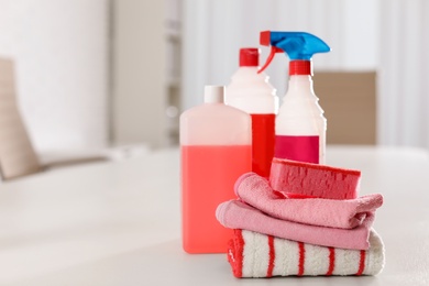 Photo of Set of professional cleaning supplies on table indoors. Space for text