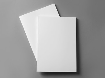 Photo of Brochures with blank covers on light grey background, top view