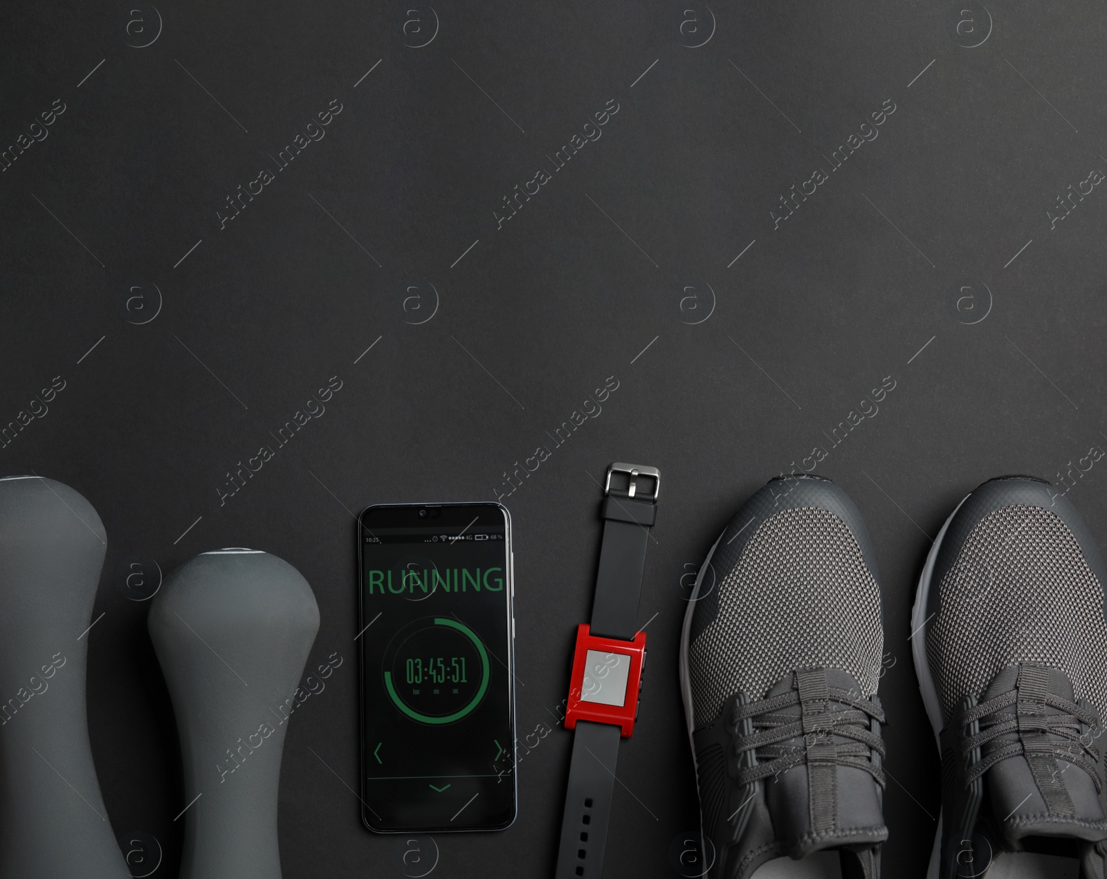 Photo of Flat lay composition with fitness equipment and smartphone on black background. Space for text