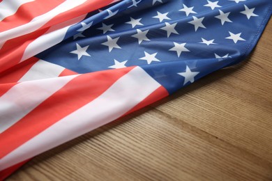 Photo of Flag of USA on wooden table, closeup. Space for text